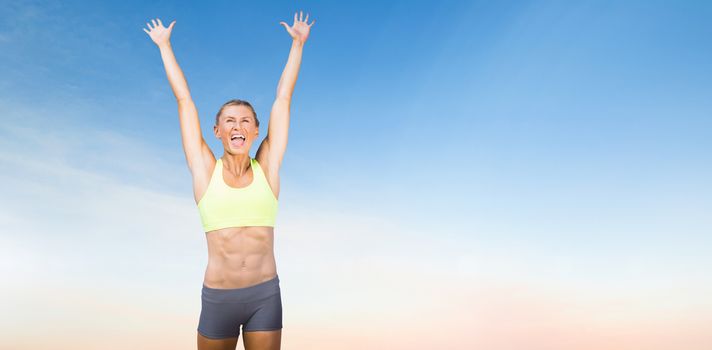 Woman cheering for success against scenic view of blue sky