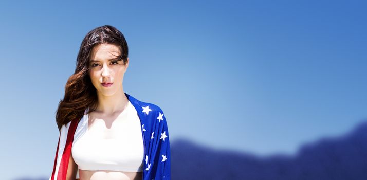 Portrait of american sportswoman is posing against scenic view of blue sky