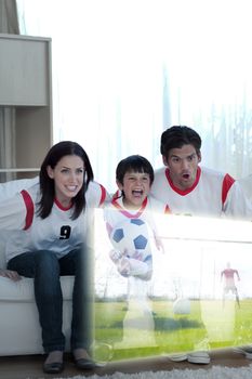 Composite image of animated family watching a football match at home