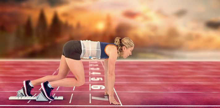 Composite image of female athlete in position ready to run on race track 