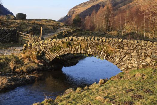 The stone packhorse bridge crossing Watendlath Beck is situated in Watendlath, Cumbria above Derwentwater in the English Lake District.