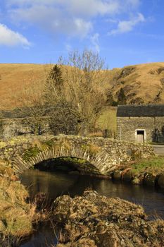 The stone packhorse bridge crossing Watendlath Beck is situated in Watendlath, Cumbria above Derwentwater in the English Lake District National Park.