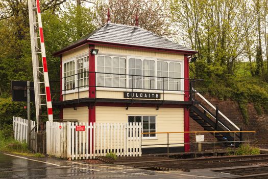 A railway crossing and traditional railway signal box at Culgaith on the historic Settle to Carlisle railway in northern England.