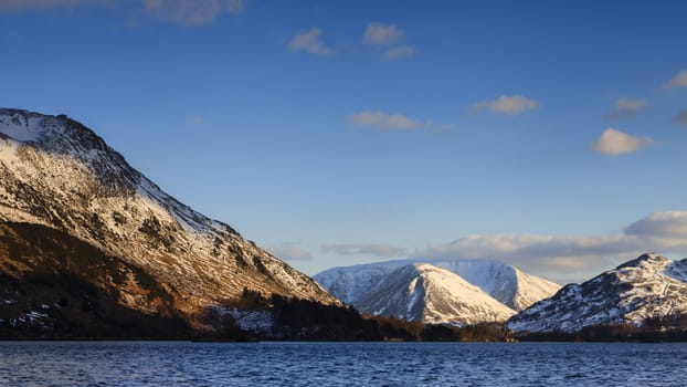 The view across Ullswater through Patterdale valley in the English Lake District national park.