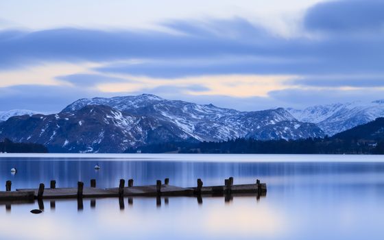 The view across Ullswater at dusk from Pooley Bridge in the English Lake District National Park.