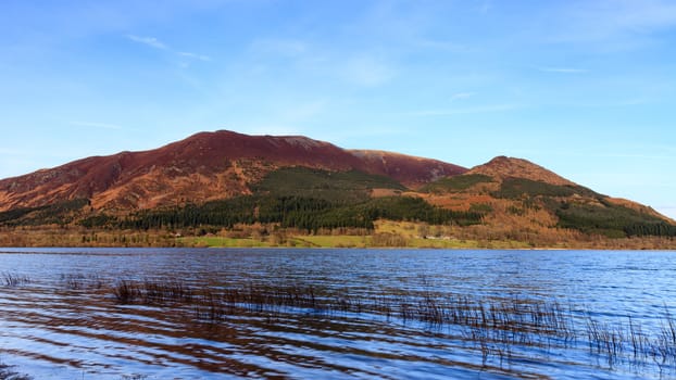 The view across Bassenthwaite Lake in the English Lake District National Park with Skiddaw mountain in the background.  Skiddaw is the fourth highest mountain in England.