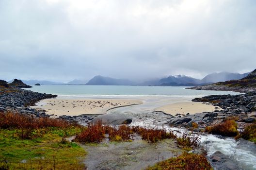 Beautiful beach with the river falling into the sea