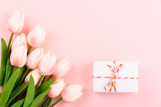 Happy Women's Day, Mother's Day concept. top view flat lay gift box and Tulip flower on pink background, copy space for your text