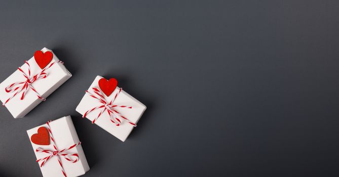 Valentine's day Concept, flat lay top view, White Gift Box and Red Heart on Gray background with copy space for your text