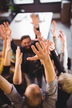 High angle view of business people cheering in creative office