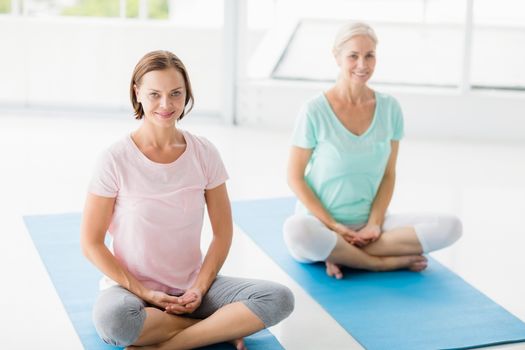 Portrait of smiling women doing yoga at fitness studio