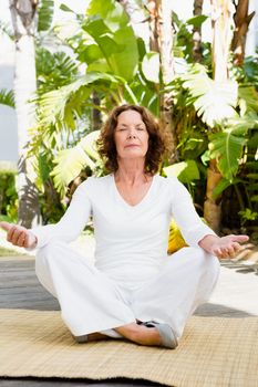 Full length of mature woman doing yoga