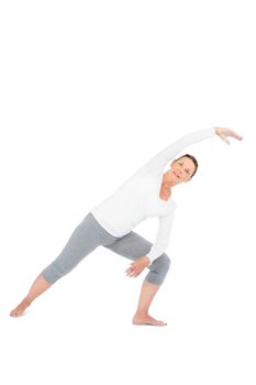 Portrait of mature woman exercising on white background