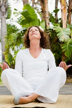 Full length of mature woman practicing yoga