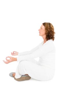 Side view of woman meditating against white background