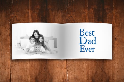 Attractive smiling father with family against overhead of wooden planks