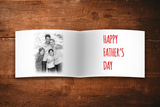 Attractive smiling father with family against overhead of wooden planks