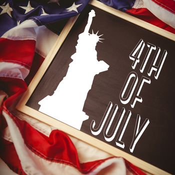 Independence day graphic against american flag on chalkboard