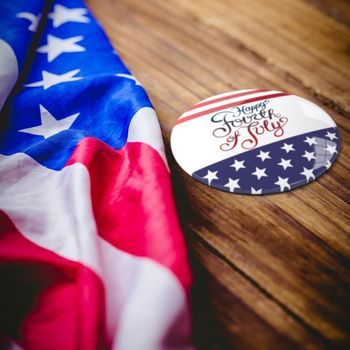Independence day graphic against usa flag on table