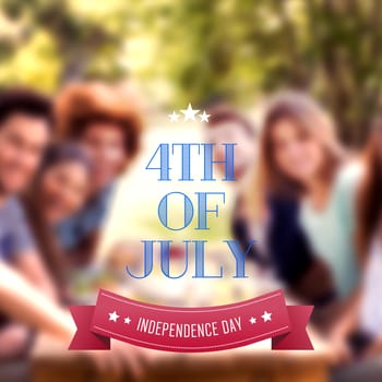 Independence day graphic against happy friends in the park having lunch