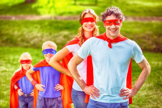 Happy family pretending to be superhero in the park