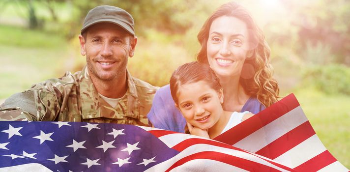 Portrait of army man with family against focus on usa flag