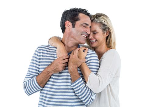 Happy mid adult romantic couple embracing against white background