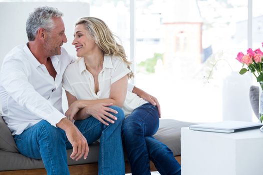 Romantic mature couple sitting face to face at home