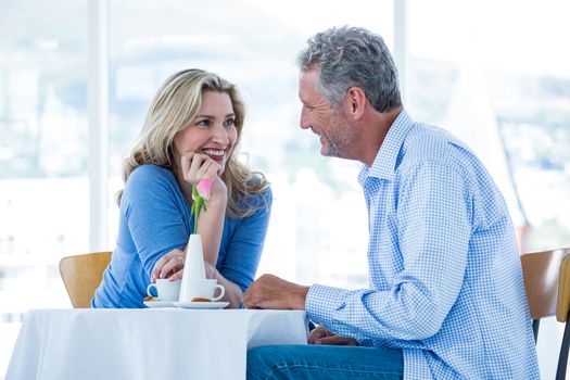 Romantic couple sitting at table in restaurant