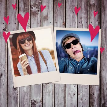 Smiling hipster woman drinking coffee against digitally generated grey wooden planks