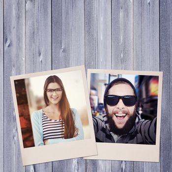 Young creative worker smiling at camera against wooden planks