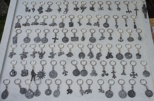 Abundance of key pendants on white table for sale