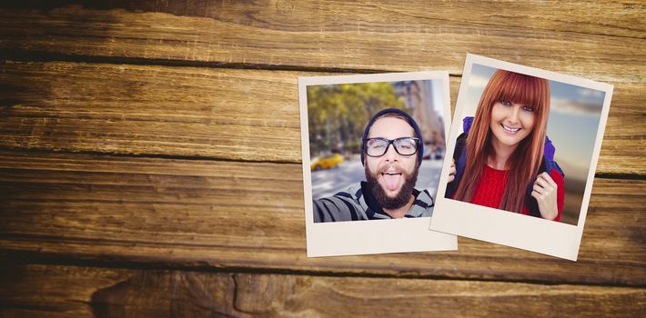Smiling hipster woman with a travel bag taking selfie against close-up of wooden flooring