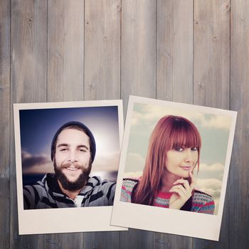 Portrait of a smiling hipster woman against pale grey wooden planks