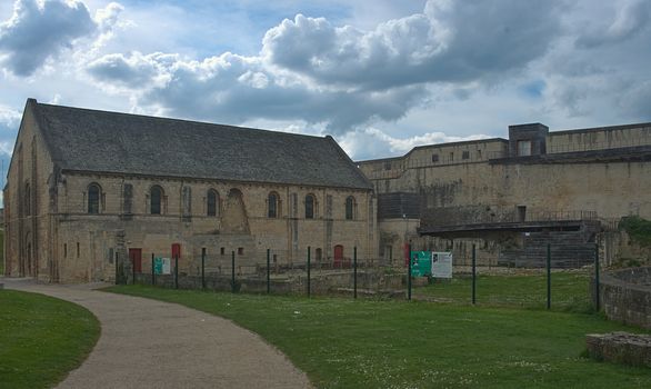 Old gothic catholic cathedral and high walls at Caen fortress, France