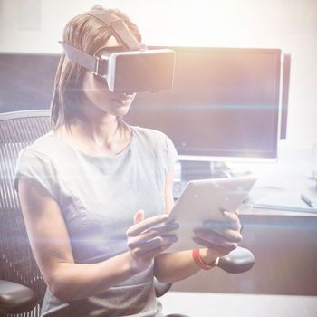 Business woman using 3D glasses in office 
