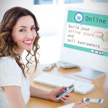 Smiling businesswoman looking at camera against screen of an online store