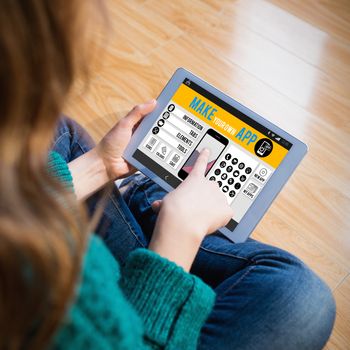 Make your own app smartphone against woman sitting on the floor while using her tablet