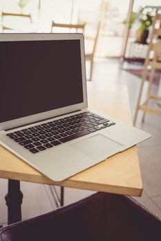 Close-up of laptop on a table at restaurant