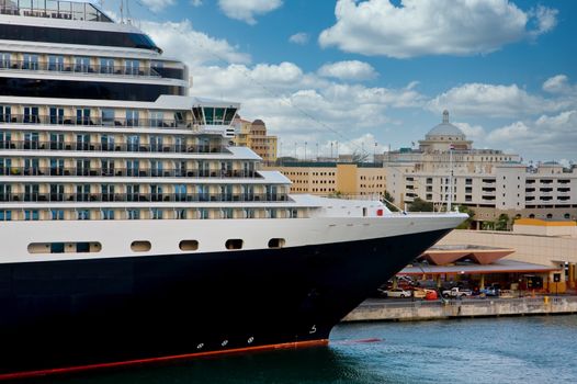 A black and white cruise ship in front of old buildings in Old San Juan, Puerto Rico