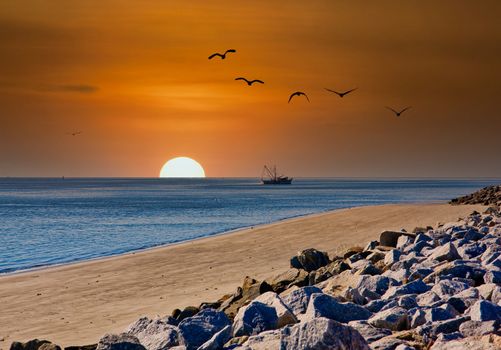 A shrimp boat off the coast of a rocky beach