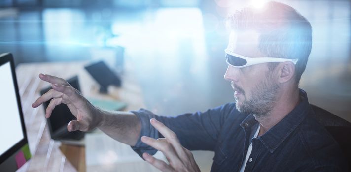 Man wearing virtual reality glass by table in office