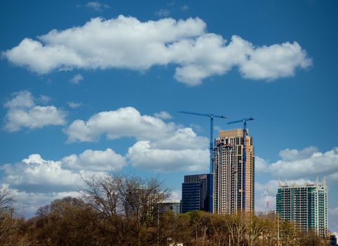 Two Blue Cranes on a construction tower