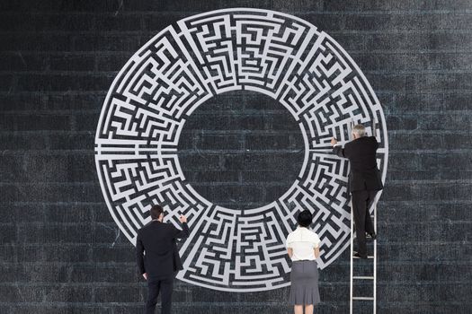 Business people drawing a maze against grey background