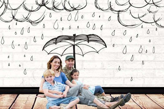 Family with a drawn umbrella sitting on the ground