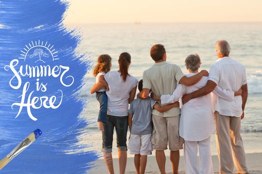 Extended family hugging at the beach on a summer day