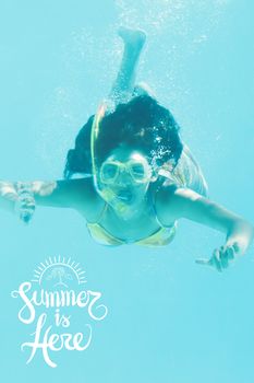 Young woman diving in the water during summer time