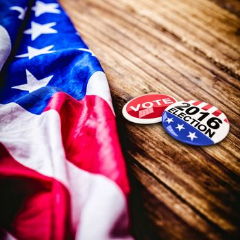 2016 election buttons against usa flag on table