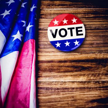 Political button against usa flag on table