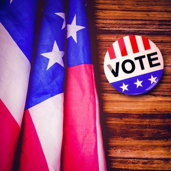 Political button against usa flag on table